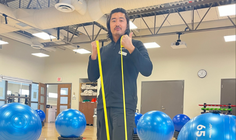 YMCA staff member holding a resistance band