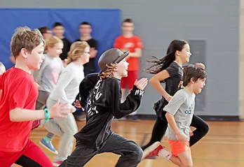 large group of youth running in gym