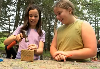 girls building at outdoor workshop