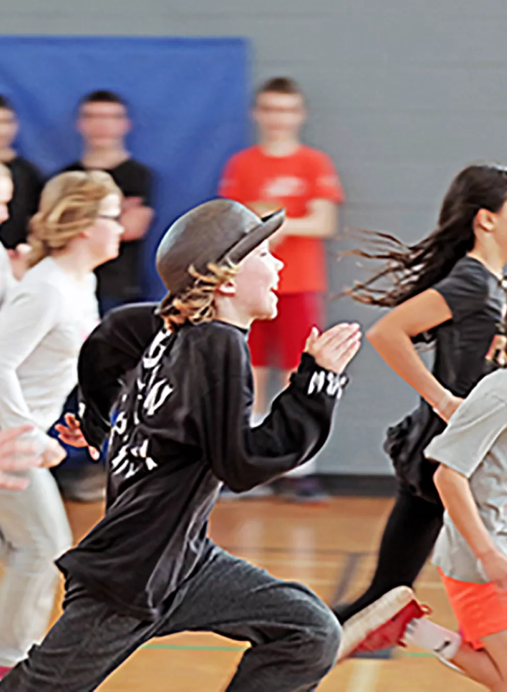 large group of youth running in gym