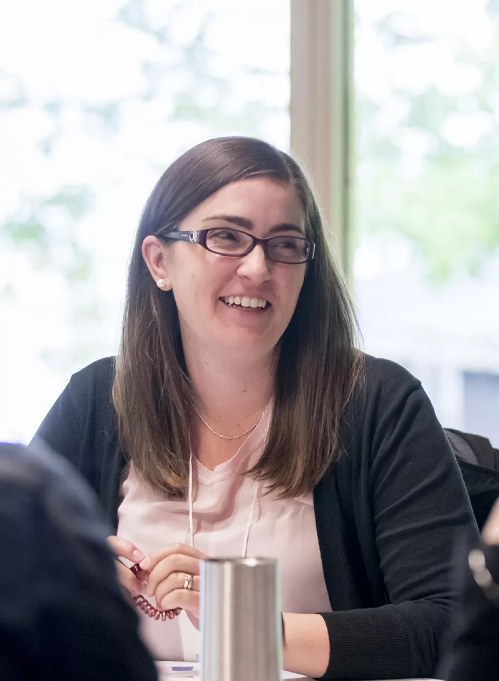 professional woman smiles in meeting