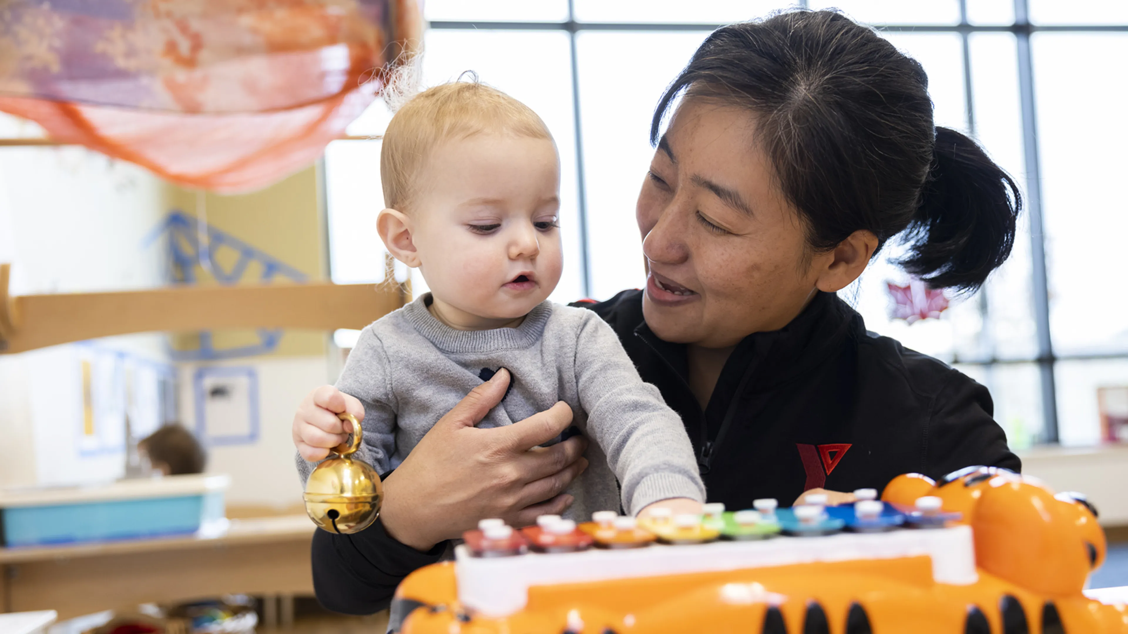 young child hugging educator