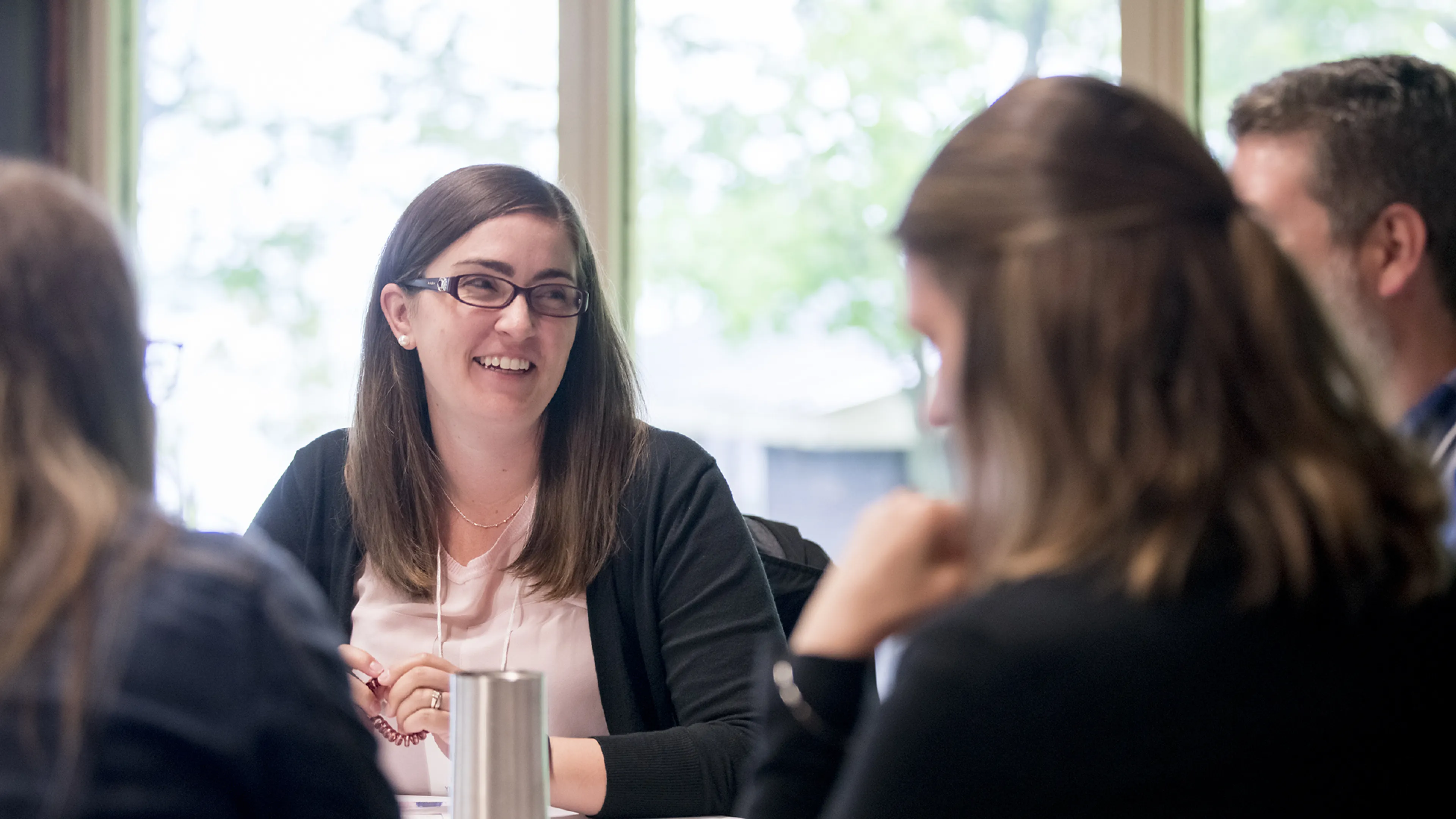 professional woman smiles in meeting