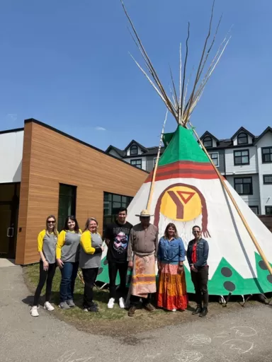 Group of people in front of tipi