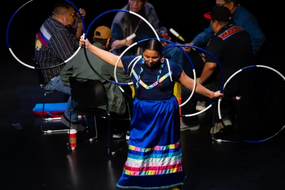 An Indigenous hoop dancer performs at the 121st Annual General Meeting.
