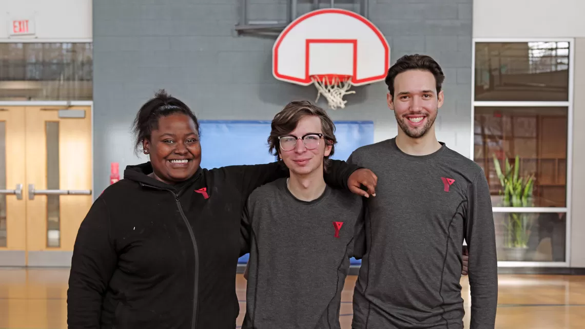 Staff in arms smiling for picture