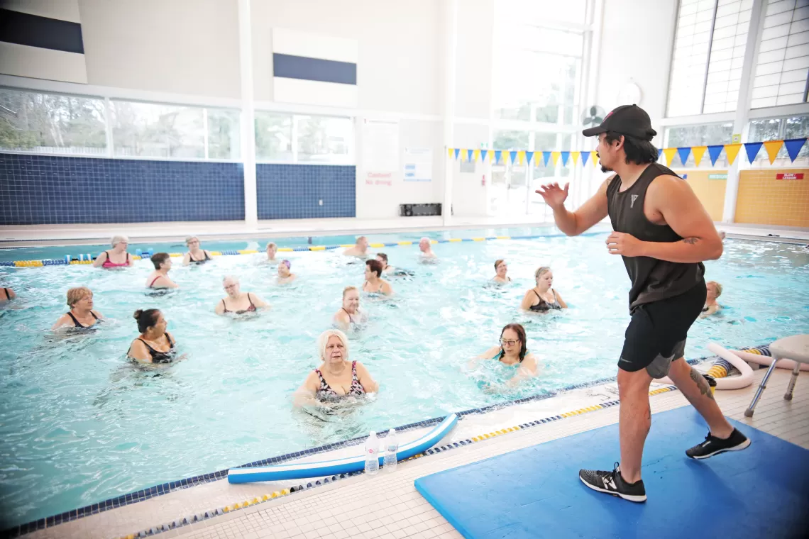 YMCA volunteer teaching an aquafit class in the pool