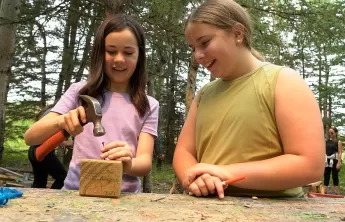 girls building at outdoor workshop