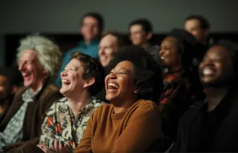 An audience of people enjoy a live performance 