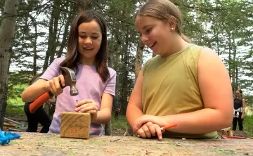 girls building at outdoor workshop
