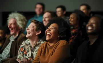 An audience of people enjoy a live performance 